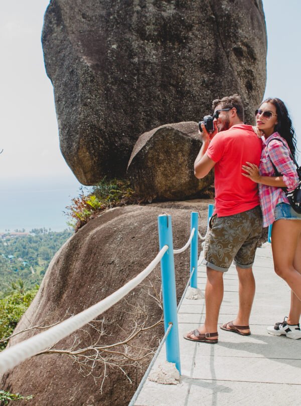 young happy hipster couple in love traveling around world, sightseeing, tropical romantic vacation in thailand, taking pictures on digital photo camera, active tourism, summer